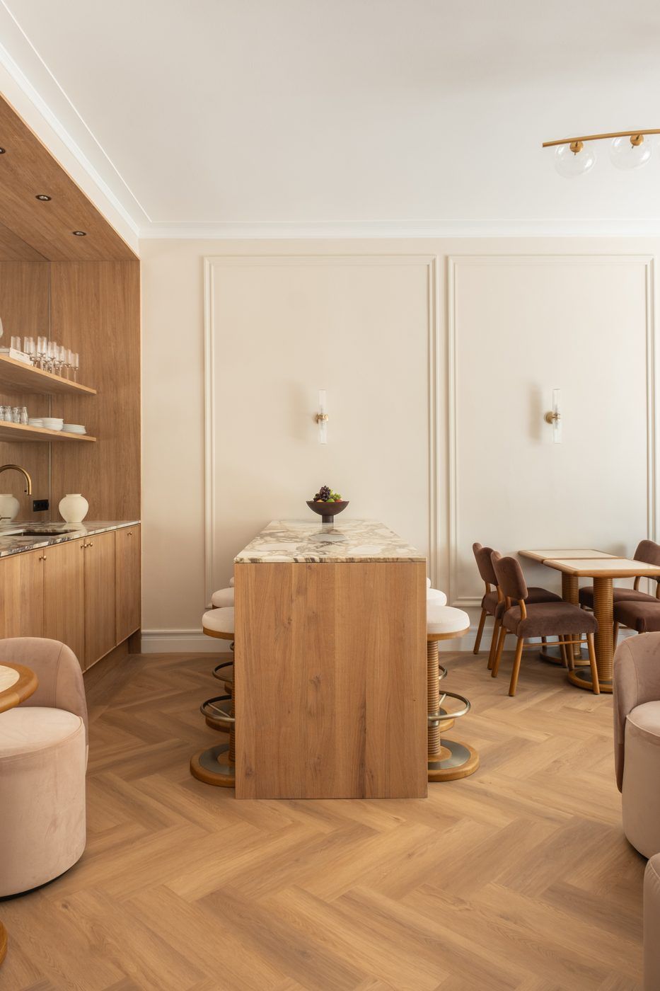 Pantry with a marble kitchen island, oak cabinetry and herringbone floor in a CreativeGrounds villa, Amsterdam Oud-Zuid