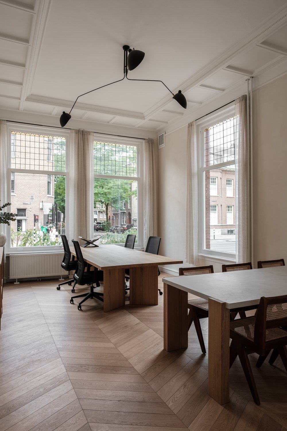 Private suite with several desks and tall windows